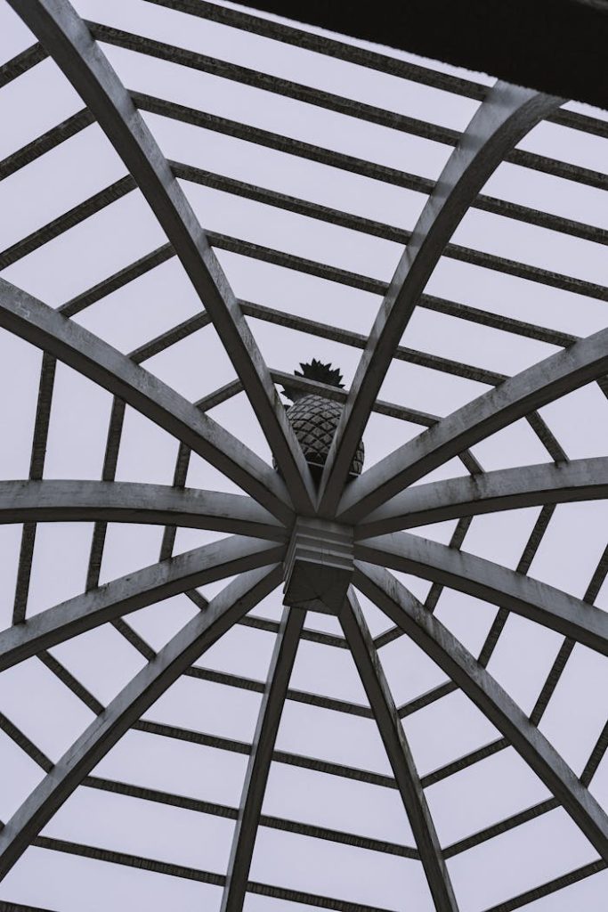Abstract view of a modern geometric dome ceiling featuring a central pineapple ornament in a low angle shot.